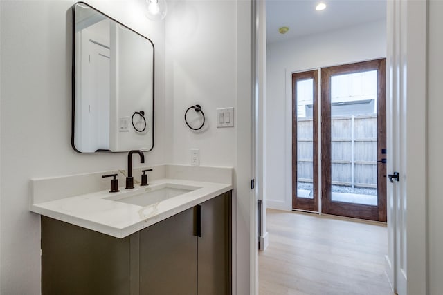 417 Wayne St, Dallas, TX 75223 - bathroom with vanity, wood finished floors, and recessed lighting