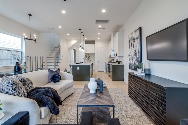 417 Wayne St, Dallas, TX 75223 - living area featuring recessed lighting, a chandelier, stairs, visible vents, and light wood-style flooring