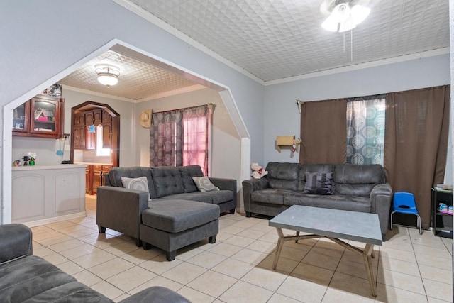 living room featuring ornamental molding and light tile patterned flooring