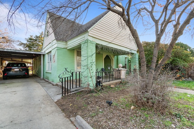 bungalow-style home featuring a carport and a porch