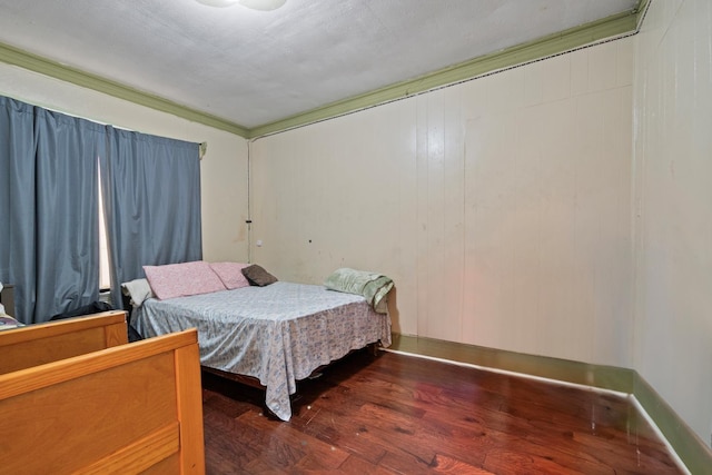 bedroom with dark hardwood / wood-style flooring