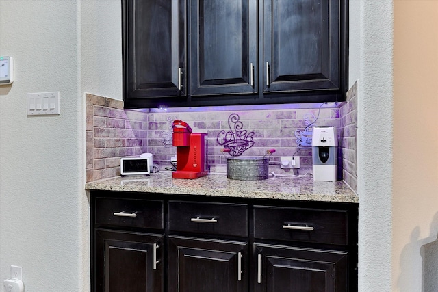 kitchen with tasteful backsplash and light stone countertops