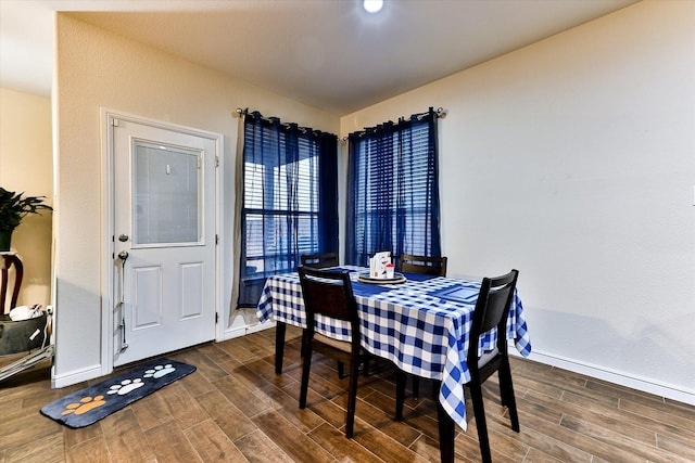 dining space with dark wood-type flooring