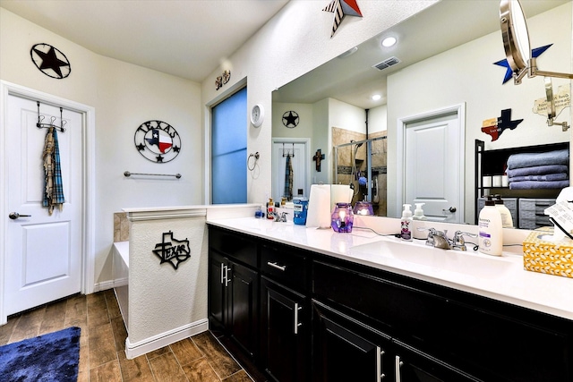 bathroom with shower with separate bathtub and vanity