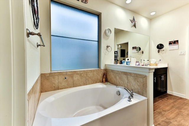 bathroom with vanity, a bathtub, and wood-type flooring