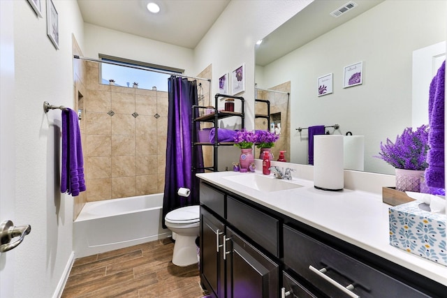 full bathroom featuring vanity, hardwood / wood-style floors, toilet, and shower / bath combo with shower curtain