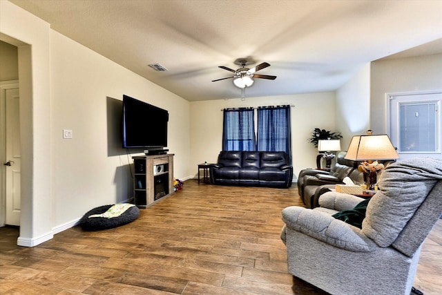 living room with hardwood / wood-style floors and ceiling fan