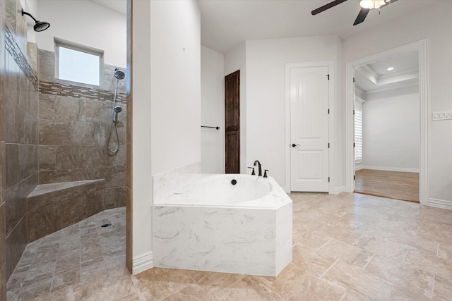 bathroom with a raised ceiling, plus walk in shower, and ceiling fan