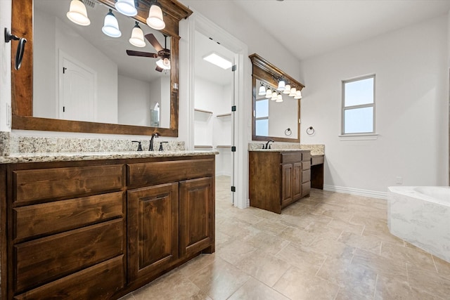 bathroom with vanity, a bath, and ceiling fan