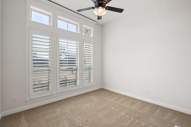 carpeted empty room with ceiling fan and a healthy amount of sunlight