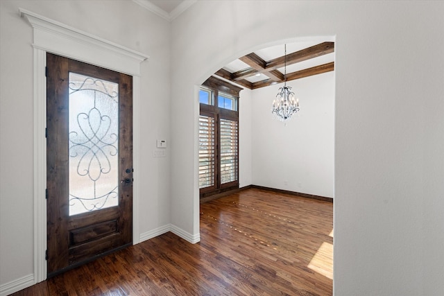 entryway with a chandelier, ornamental molding, coffered ceiling, dark wood-type flooring, and beam ceiling