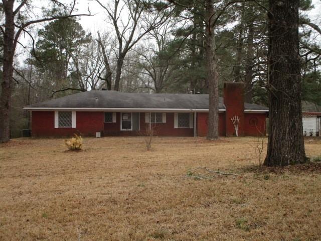 rear view of property with a lawn