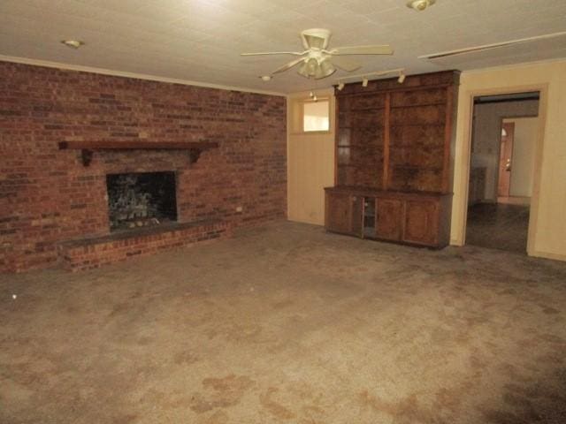 3359 Green Terrace Rd, Shreveport, LA 71118 - unfurnished living room featuring ceiling fan, brick wall, carpet floors, and a brick fireplace