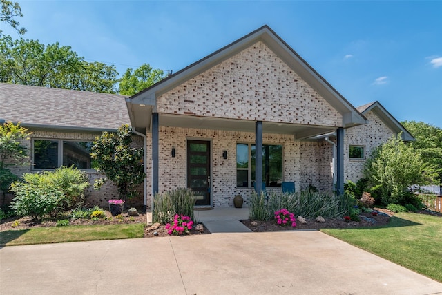 477 Lakepoint Loop, Pottsboro, TX 75076 - view of front facade featuring covered porch and brick siding
