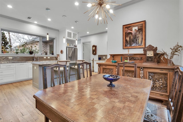 477 Lakepoint Loop, Pottsboro, TX 75076 - dining area featuring visible vents, a chandelier, light wood-style floors, ornamental molding, and recessed lighting