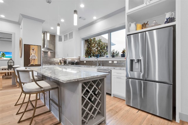 477 Lakepoint Loop, Pottsboro, TX 75076 - kitchen with wall chimney range hood, decorative backsplash, crown molding, appliances with stainless steel finishes, and white cabinets