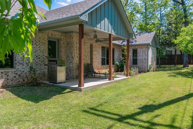 477 Lakepoint Loop, Pottsboro, TX 75076 - rear view of property featuring brick siding, a shingled roof, board and batten siding, a patio area, and a yard