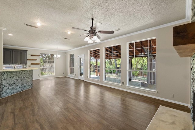 unfurnished living room featuring crown molding, a textured ceiling, and visible vents