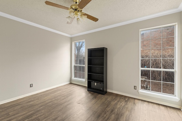 unfurnished room featuring crown molding, ceiling fan, a textured ceiling, baseboards, and dark wood-style floors