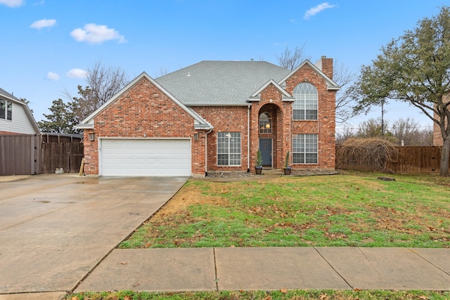 traditional-style home featuring fence, driveway, a front lawn, and a garage