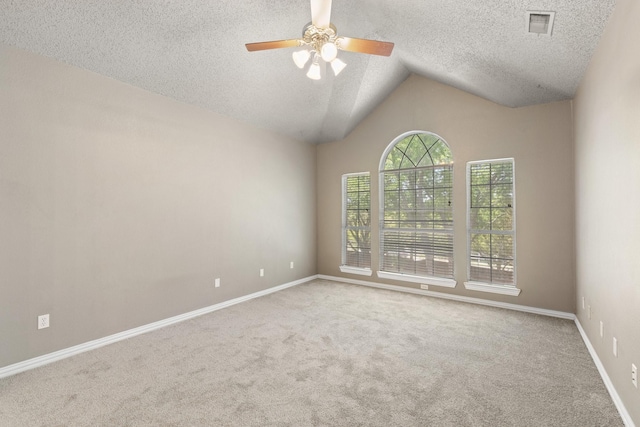 unfurnished room featuring a ceiling fan, a textured ceiling, baseboards, lofted ceiling, and carpet flooring