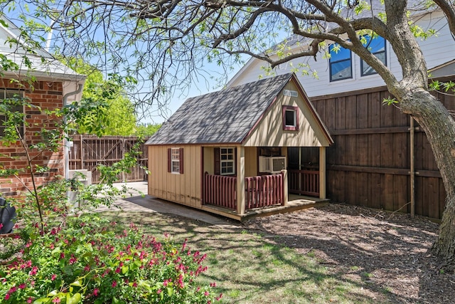 view of outbuilding with a fenced backyard and an outdoor structure
