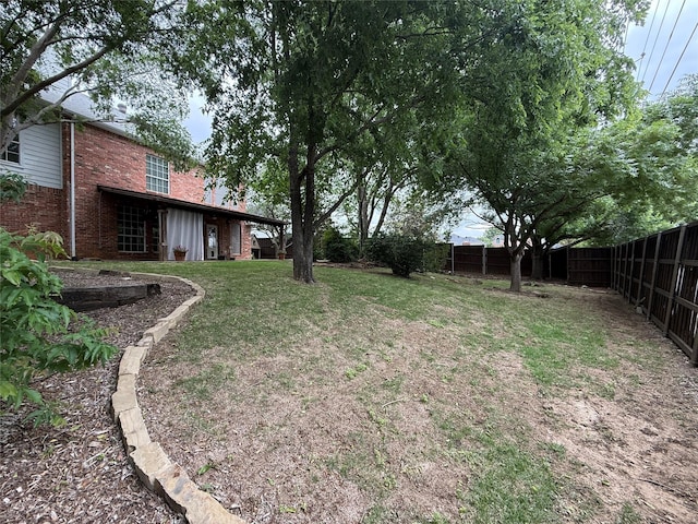 view of yard with a fenced backyard