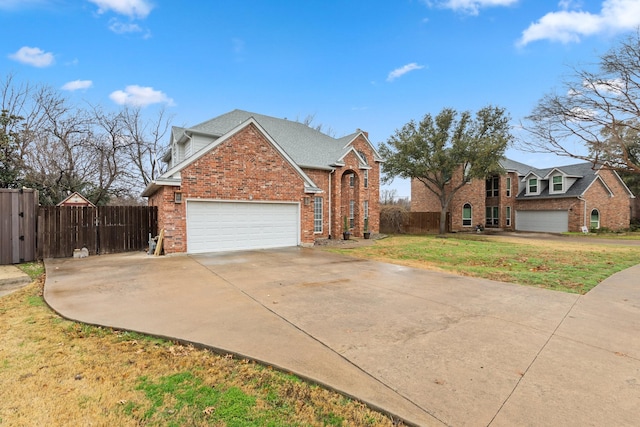 view of front of house featuring brick siding, fence, and driveway