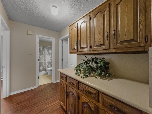 kitchen featuring dark wood-type flooring and a textured ceiling