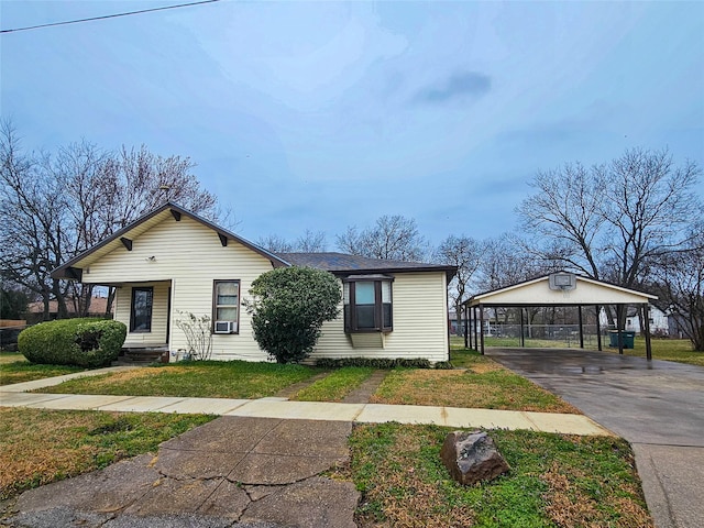 view of front of house featuring a front lawn and a carport