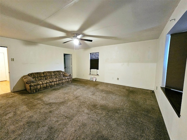 unfurnished living room featuring dark colored carpet and ceiling fan