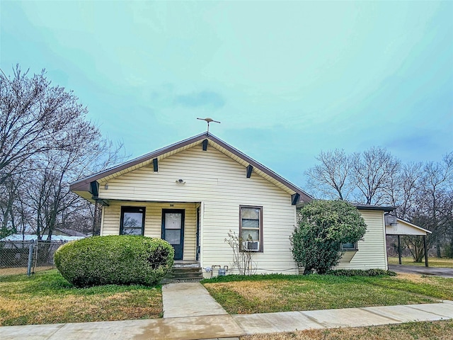 bungalow-style home with a front yard