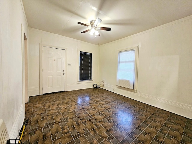 unfurnished room featuring ornamental molding and ceiling fan