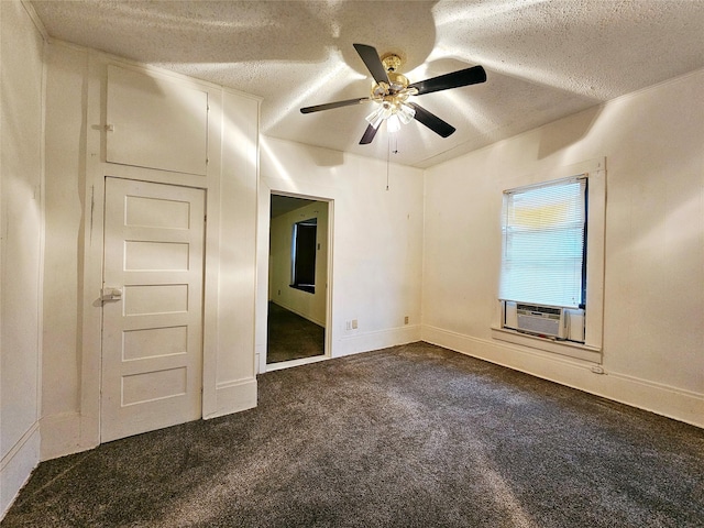 carpeted spare room featuring ceiling fan, cooling unit, and a textured ceiling