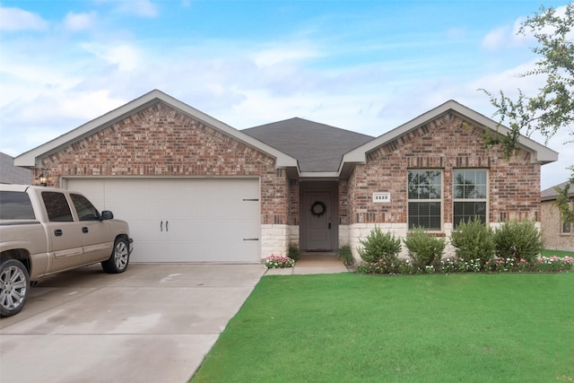 view of front of property featuring a garage and a front lawn