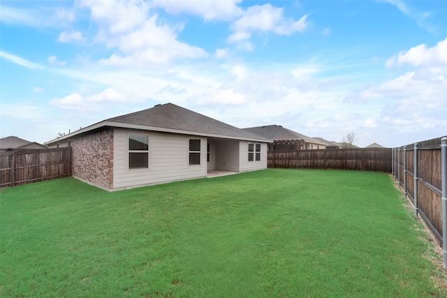 back of house featuring a yard