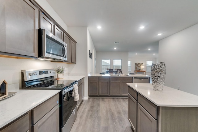 kitchen featuring sink, light hardwood / wood-style flooring, and appliances with stainless steel finishes