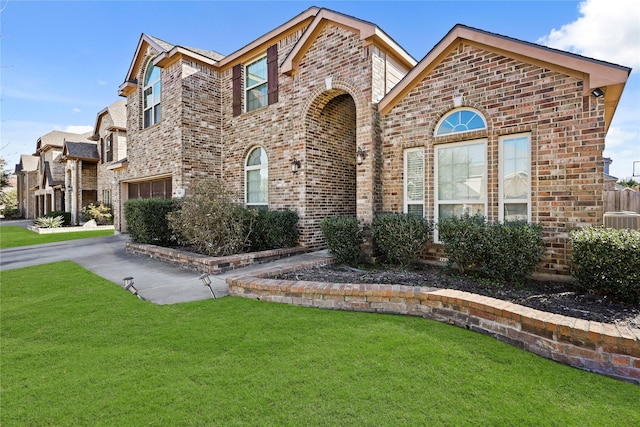 view of front of house featuring a garage, a front lawn, and central air condition unit