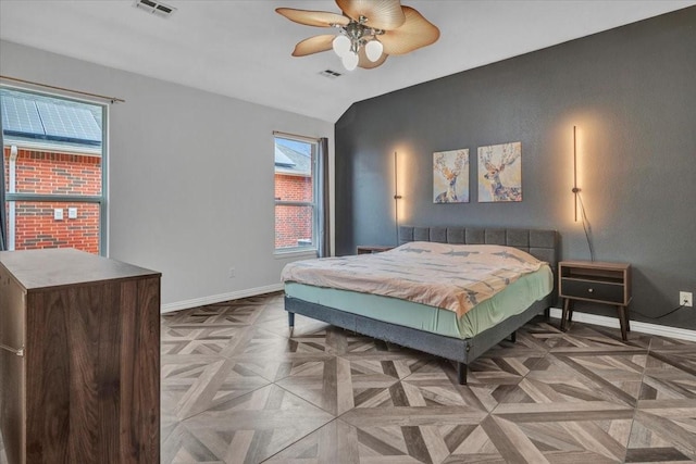 bedroom featuring ceiling fan, light parquet flooring, and lofted ceiling