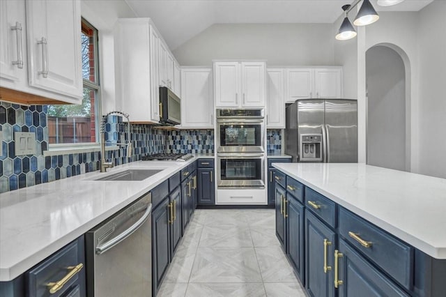 kitchen with blue cabinetry, sink, hanging light fixtures, appliances with stainless steel finishes, and white cabinets