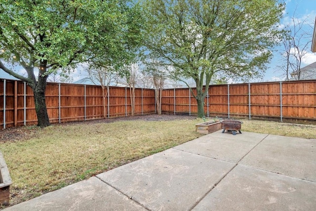 view of yard with a fire pit and a patio