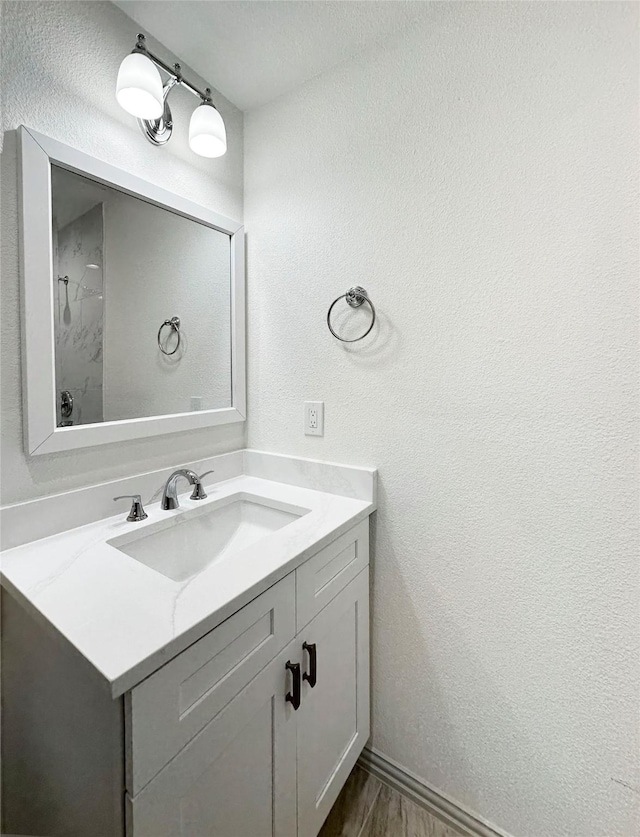 bathroom featuring hardwood / wood-style flooring and vanity