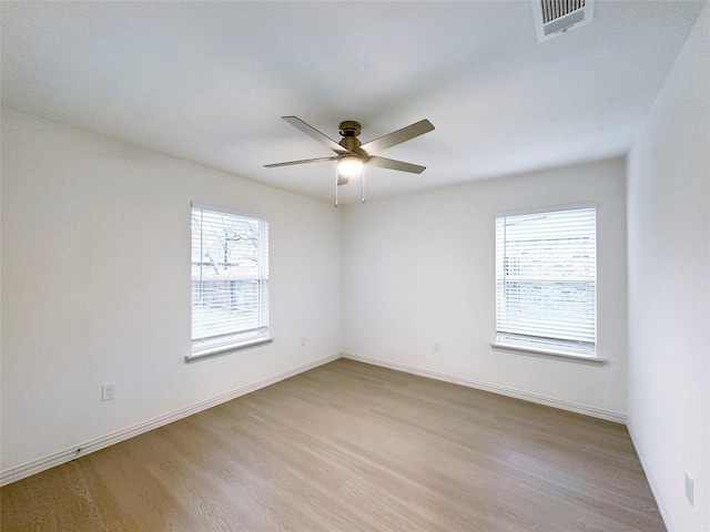 spare room featuring ceiling fan and light hardwood / wood-style flooring