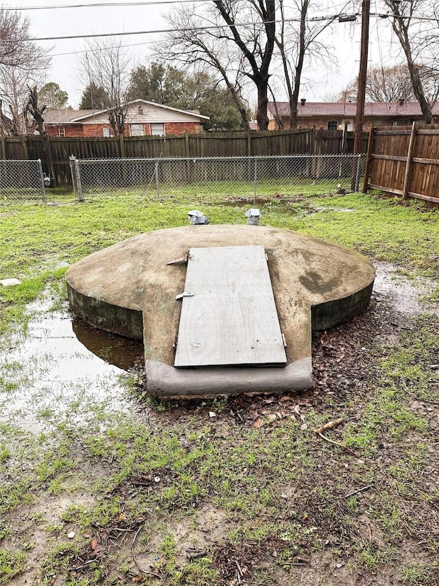 view of storm shelter featuring a lawn