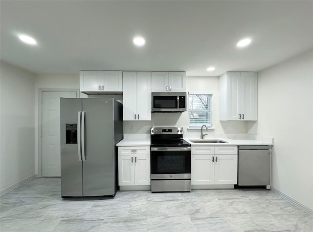 kitchen with white cabinetry, sink, and appliances with stainless steel finishes