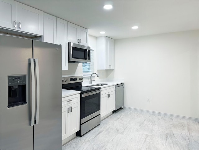 kitchen featuring white cabinetry, appliances with stainless steel finishes, and sink