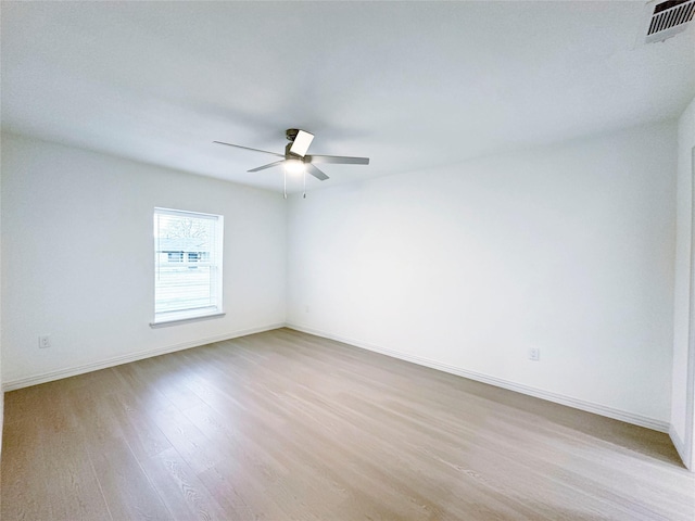 empty room featuring ceiling fan and light hardwood / wood-style floors