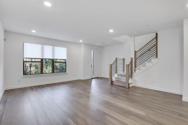 unfurnished living room featuring hardwood / wood-style flooring