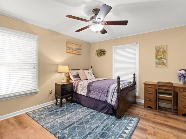 bedroom with ornamental molding, hardwood / wood-style floors, and ceiling fan