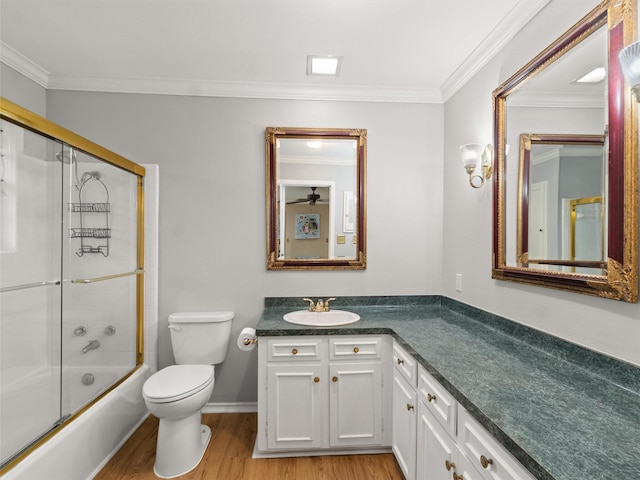 full bathroom with enclosed tub / shower combo, vanity, wood-type flooring, ornamental molding, and toilet